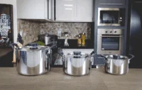 Jogo de Panelas Tramontina Grano Compact em Aço Inox com Corpo Triplo e Alças com Revestimento em Silicone Preto 3 Peças