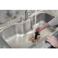 Triturador de Resíduos Alimentares Tramontina para Cubas ou Pias com Furação para Válvula de 4 1/2" com Potência de 0,75 HP 127 V